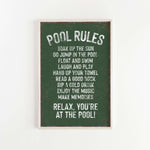 a green sign that says pool rules hanging on a wall