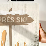 a hand holding up a sign with skis on it