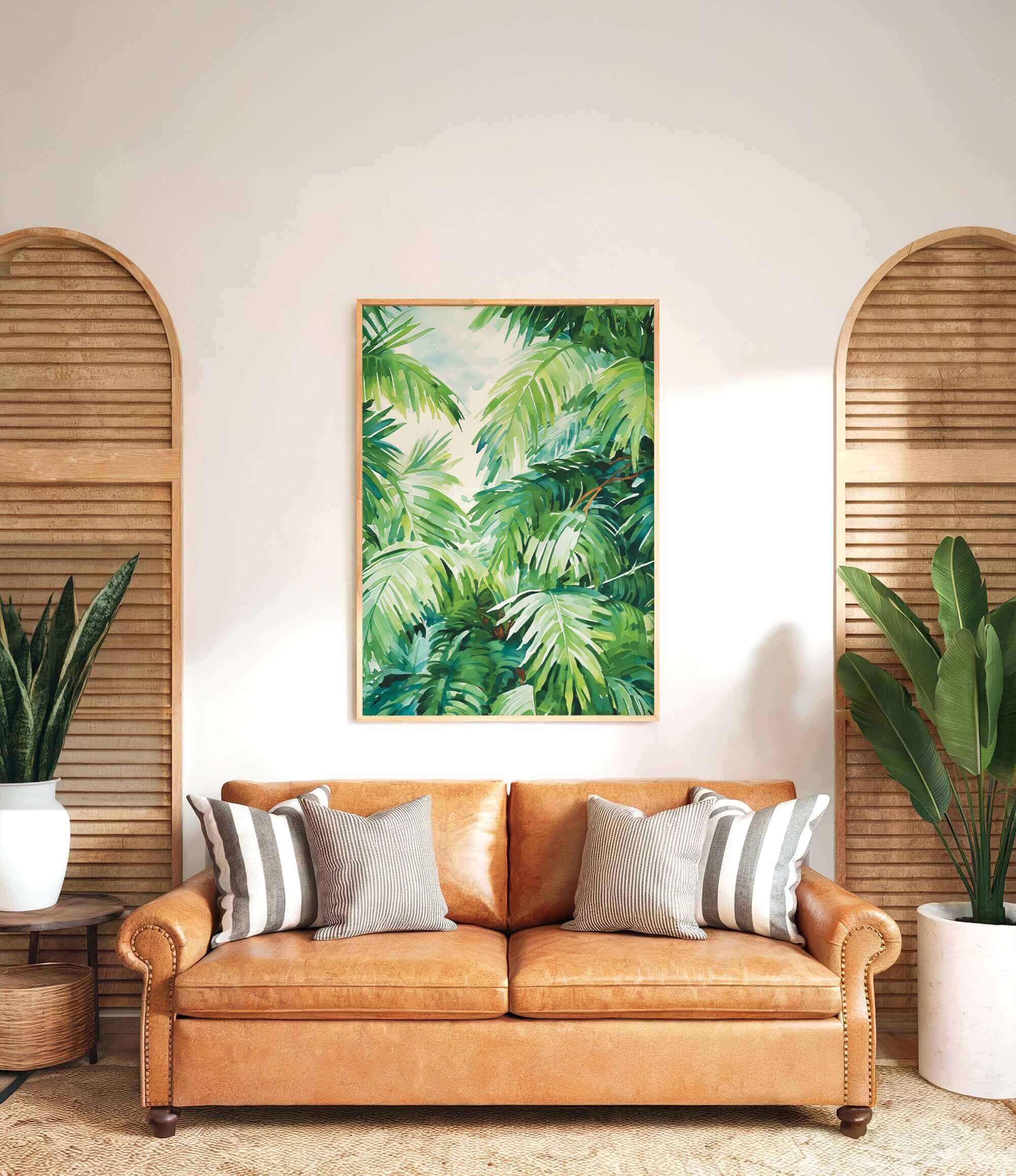 a living room with a large, vibrant painting of lush green palm leaves hanging on the wall above a brown leather sofa with striped pillows.
