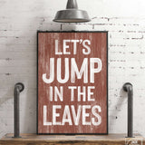 a wooden sign that says let's jump in the leaves