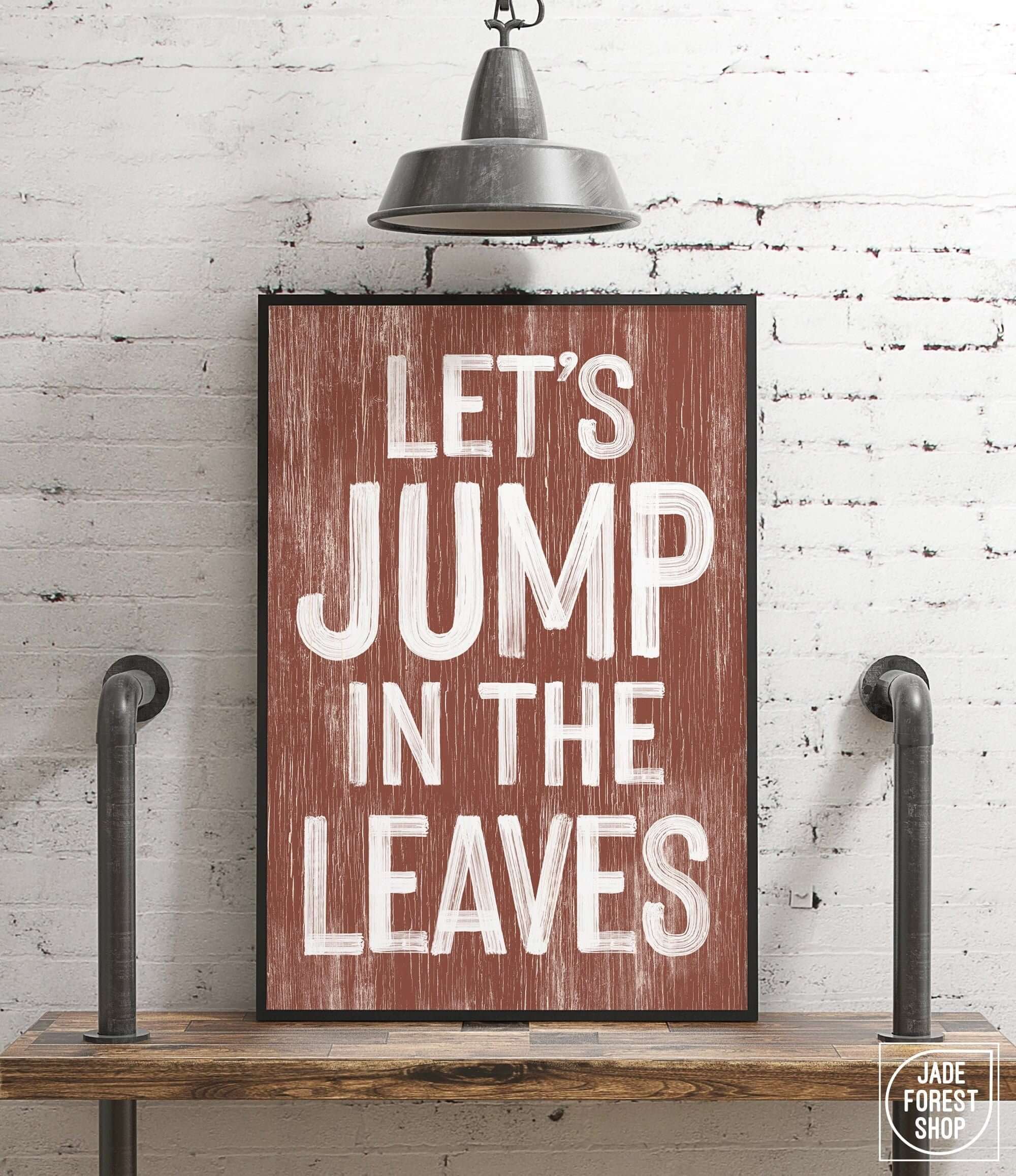 a wooden sign that says let's jump in the leaves