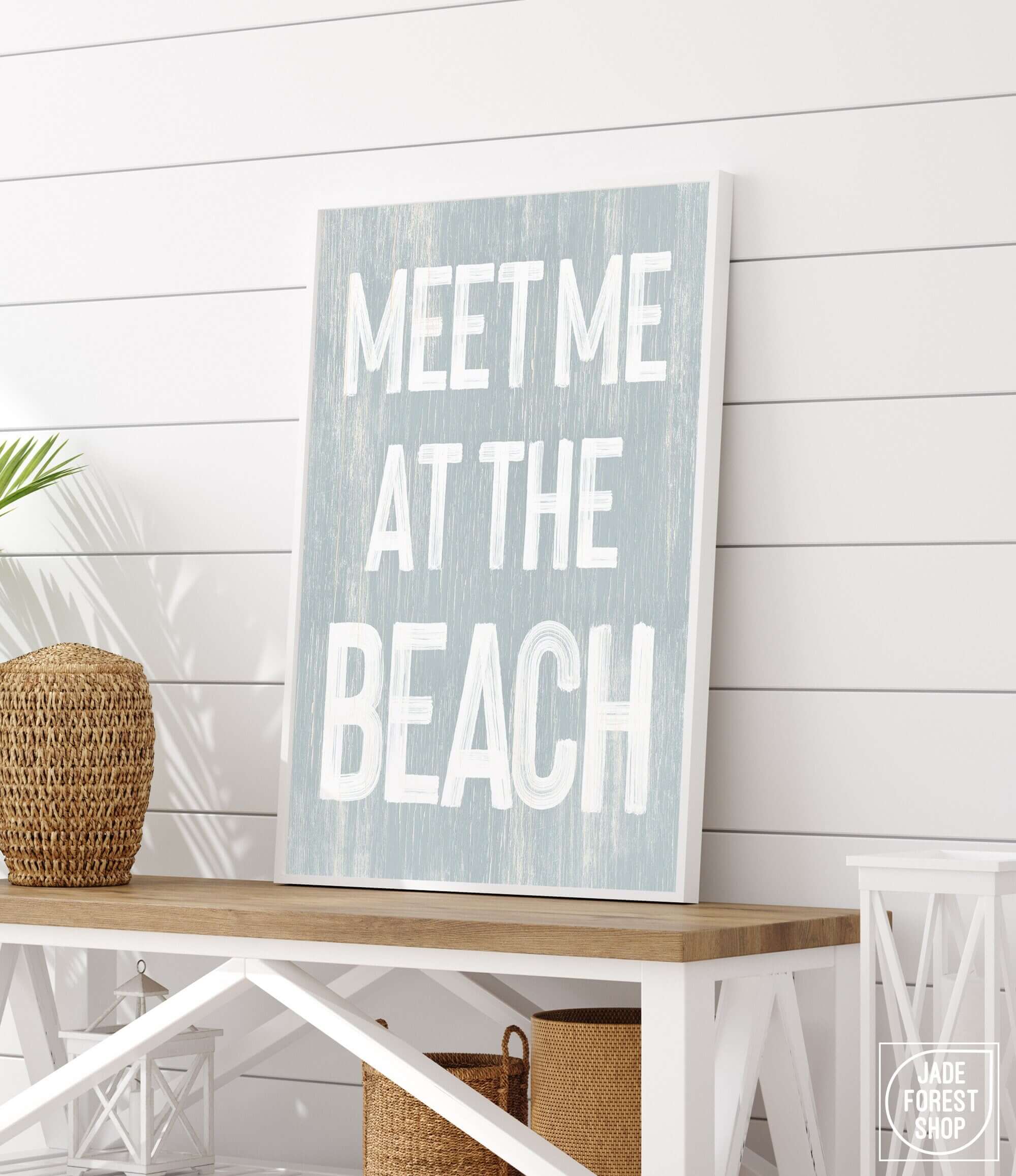 a wooden sign that says meet me at the beach