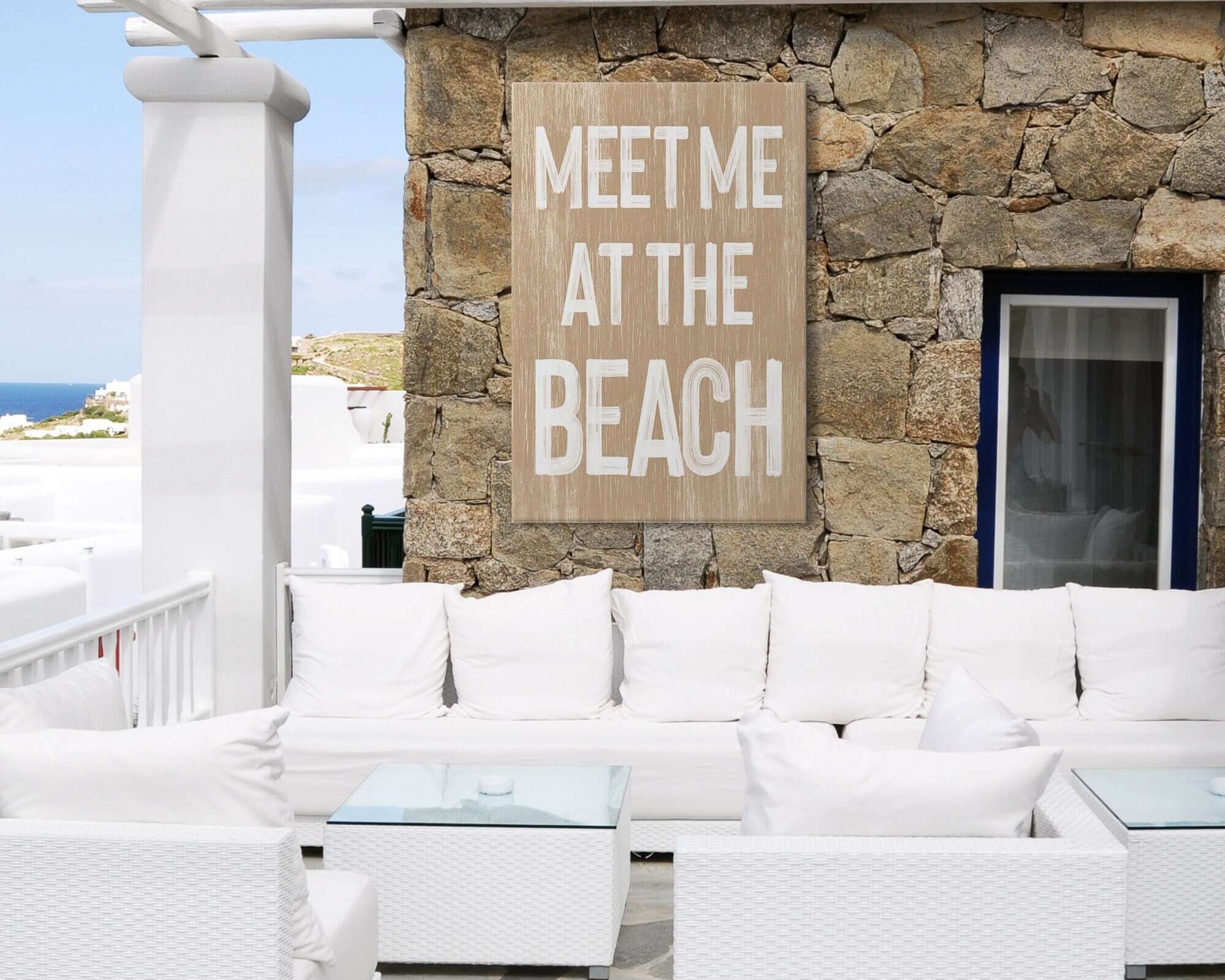 a white couch sitting under a wooden sign