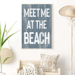 a blue and white sign that says meet me at the beach