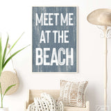 a blue and white sign that says meet me at the beach