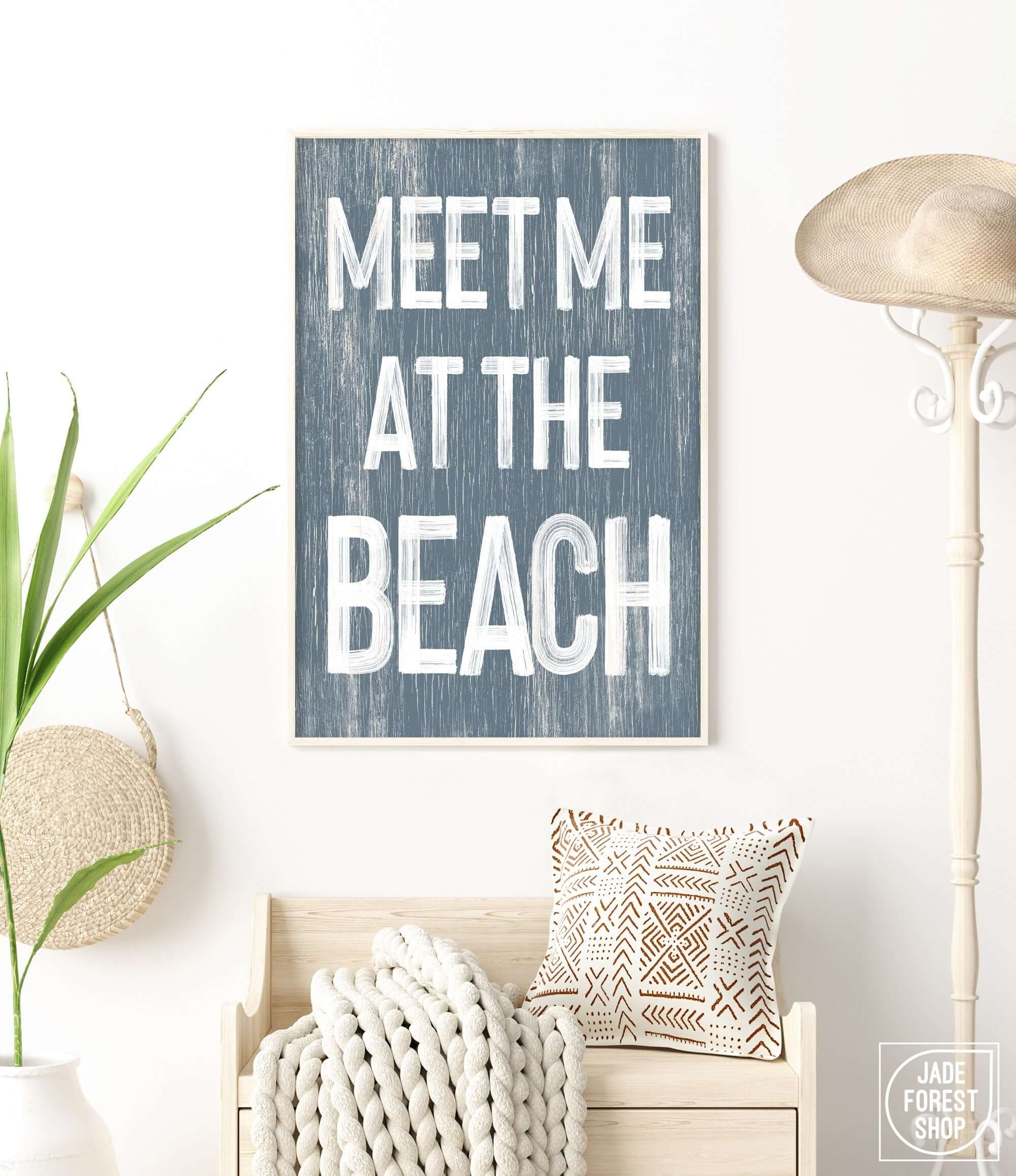 a blue and white sign that says meet me at the beach