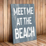 a wooden sign that says meet me at the beach