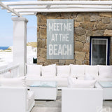 a white couch sitting on top of a patio next to a stone wall