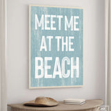 a blue and white sign that says meet me at the beach