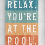 a sign that says relax, you're at the pool