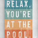 a sign that says relax, you're at the pool