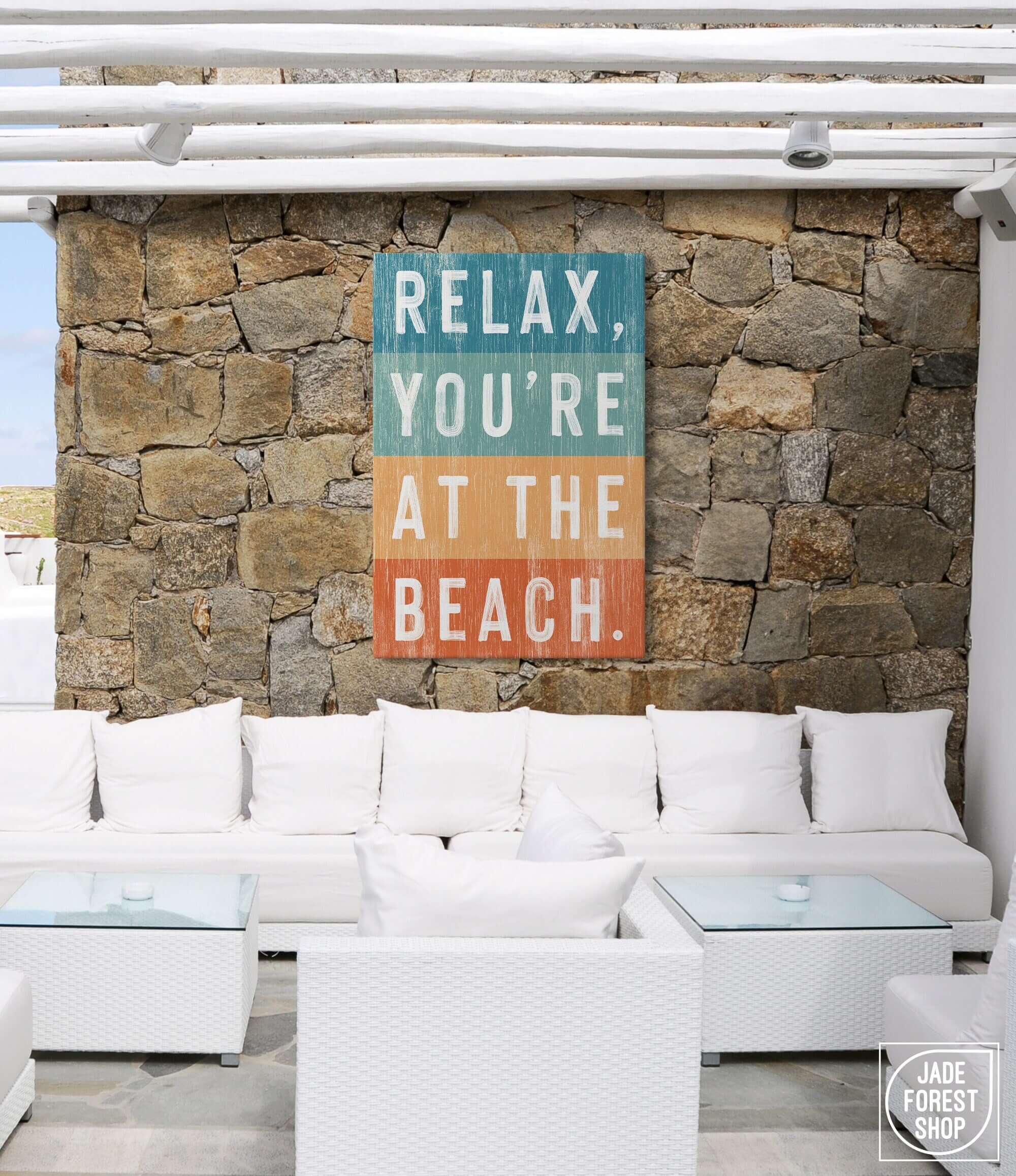 a white couch sitting in front of a stone wall