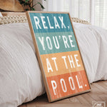 a wooden sign that says relax, you're at the pool