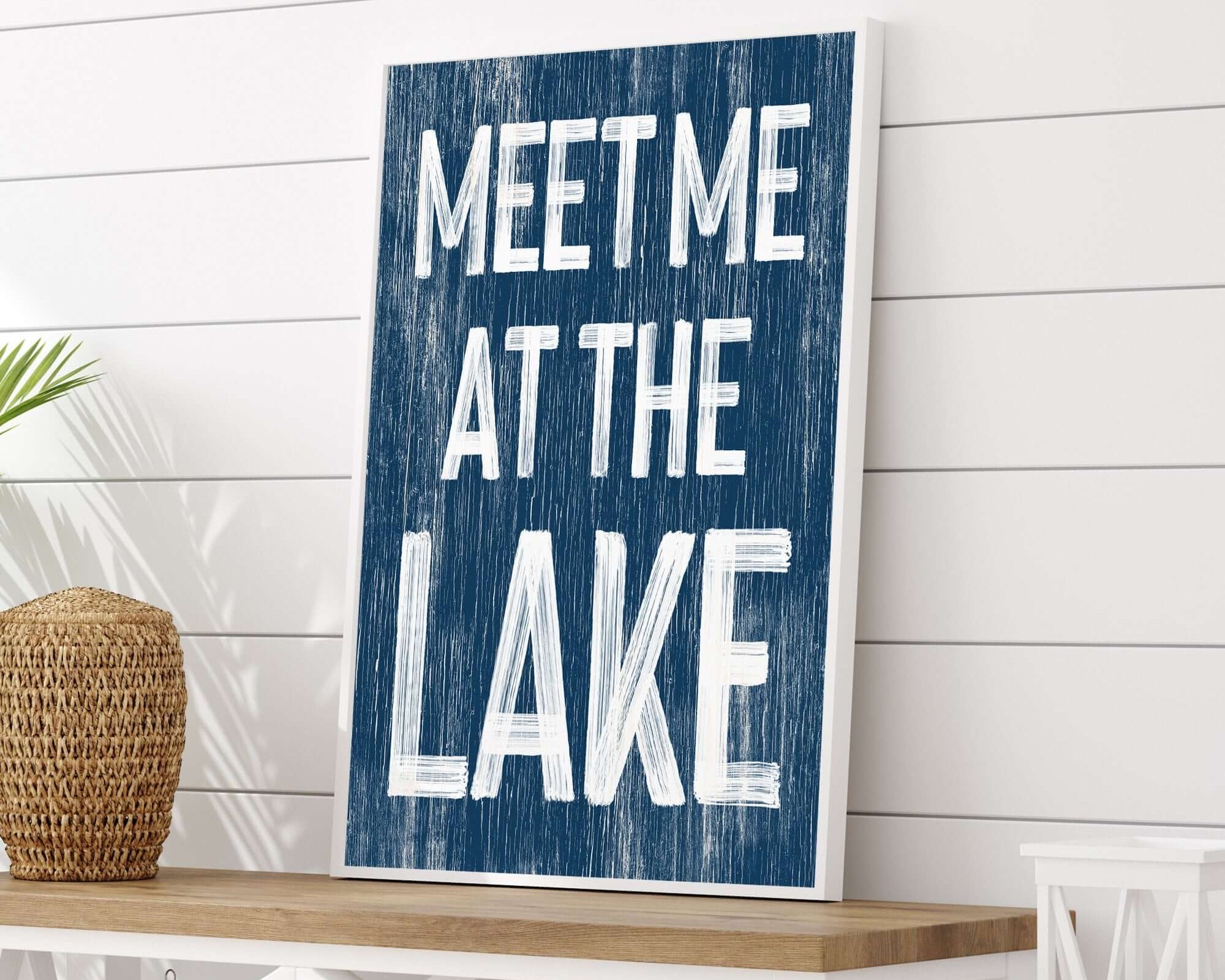 The Meet Me at the Lake Sign, Nautical features bold white letters on a blue background—ideal for lake house decor or bringing a vintage nautical touch to modern farmhouse style.