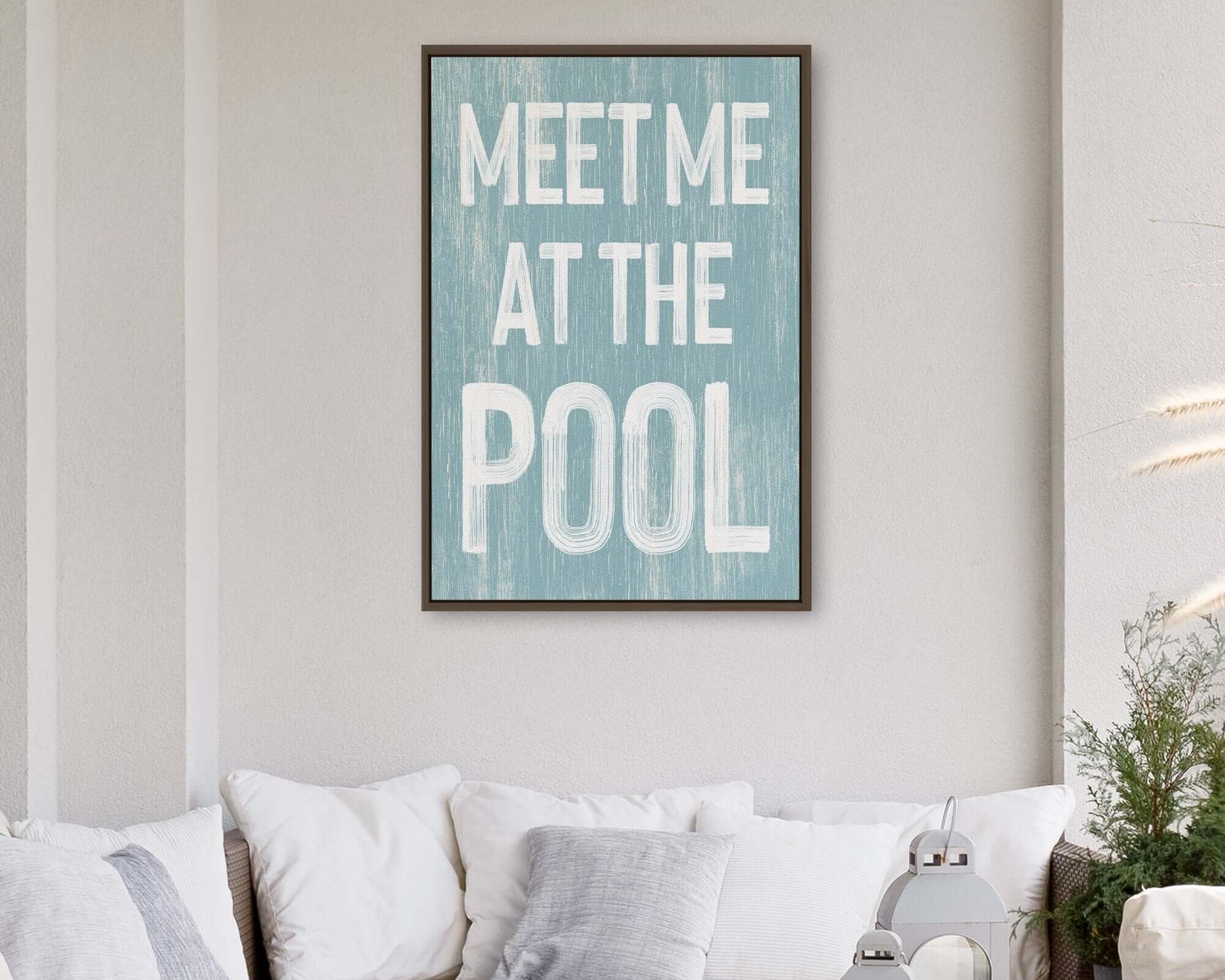 Create a cozy patio vibe with the Meet Me at the Pool Sign, Tide—a retro accent perfect for adding vintage home decor charm above a white sofa.