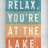 a sign that says relax, you're at the lake