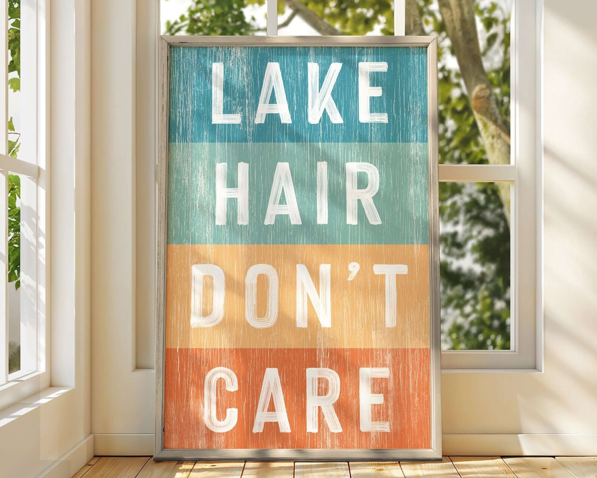 a sign that says lake hair don't care in front of a window
