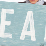 a woman holding a sign that says eat