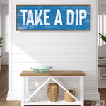 a blue and white sign that says take a dip