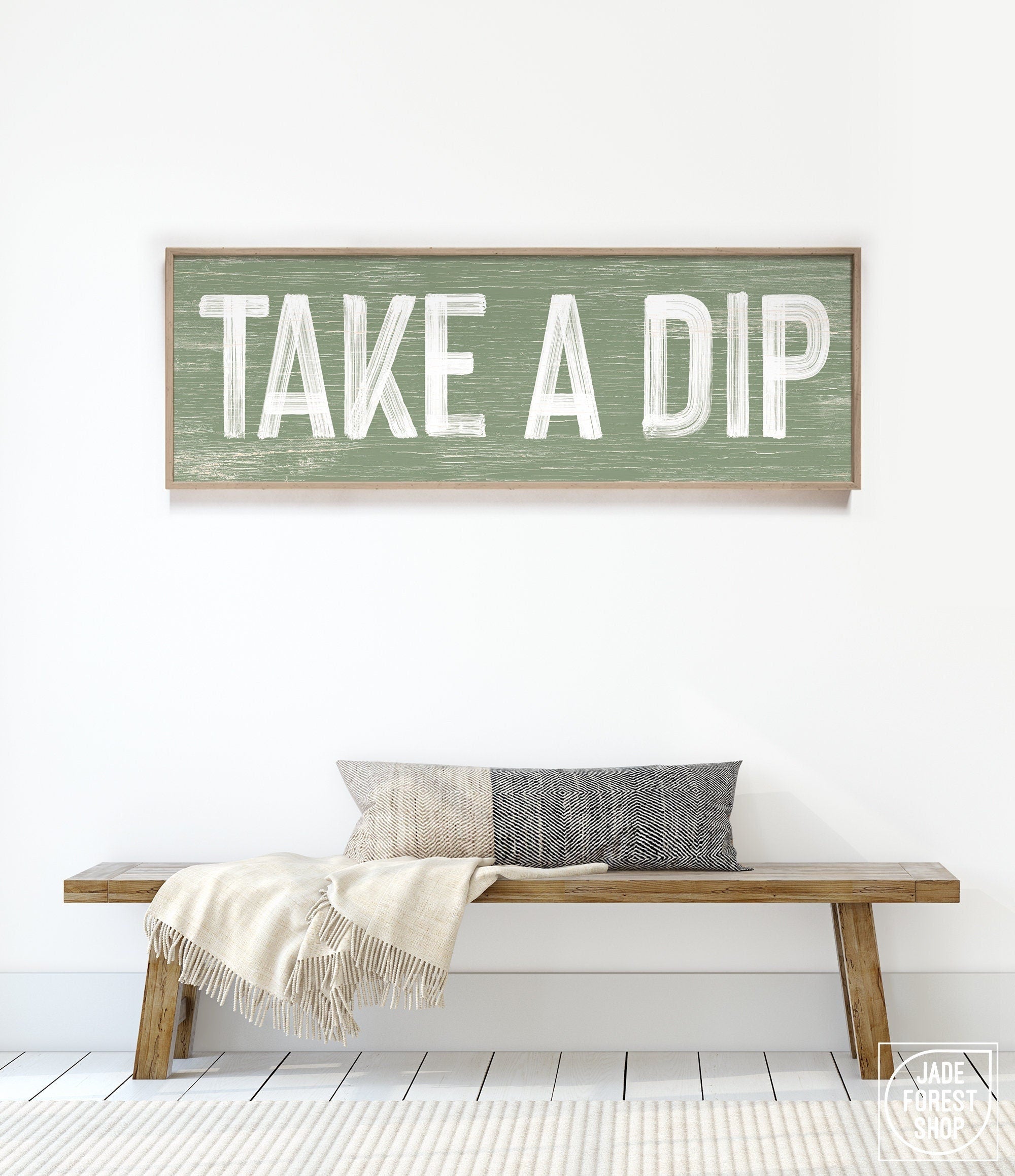 a wooden sign that says take a dip on a bench