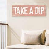 a couch with pillows and a sign that says take a dip