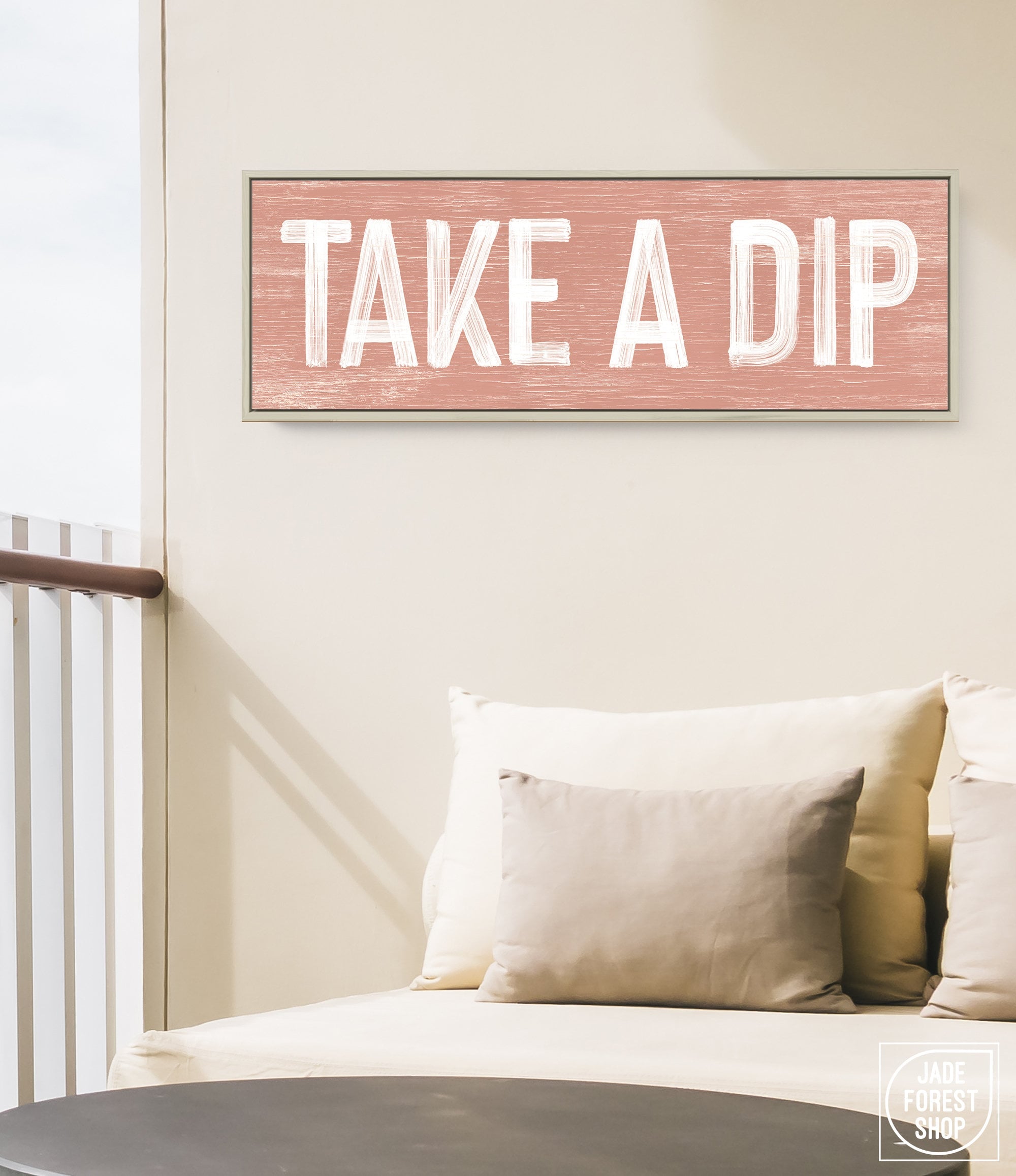 a couch with pillows and a sign that says take a dip