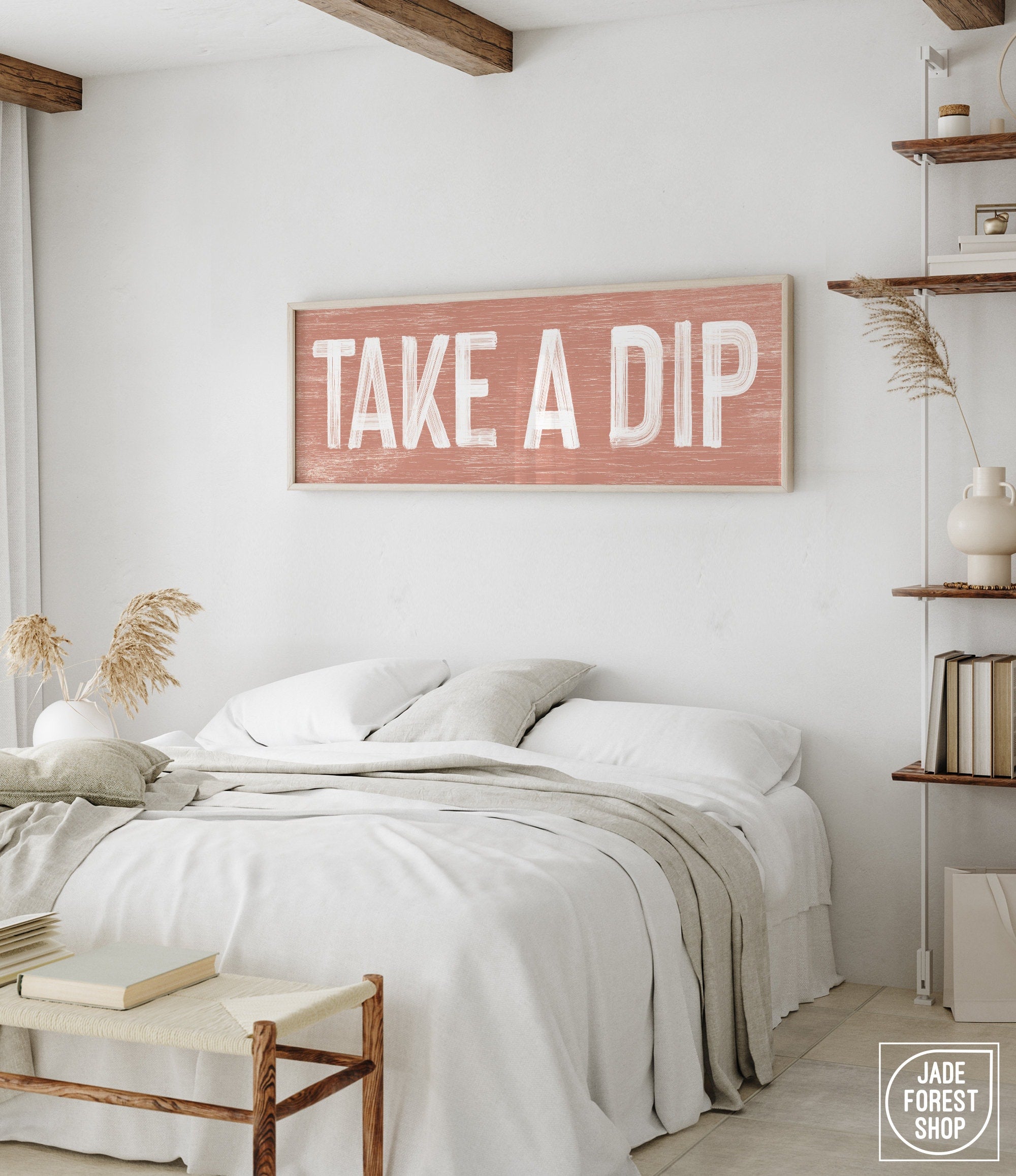 a bedroom with a bed and a wooden sign on the wall