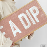 a woman holding a sign that says fadip