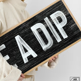 a woman holding a sign that says fadip