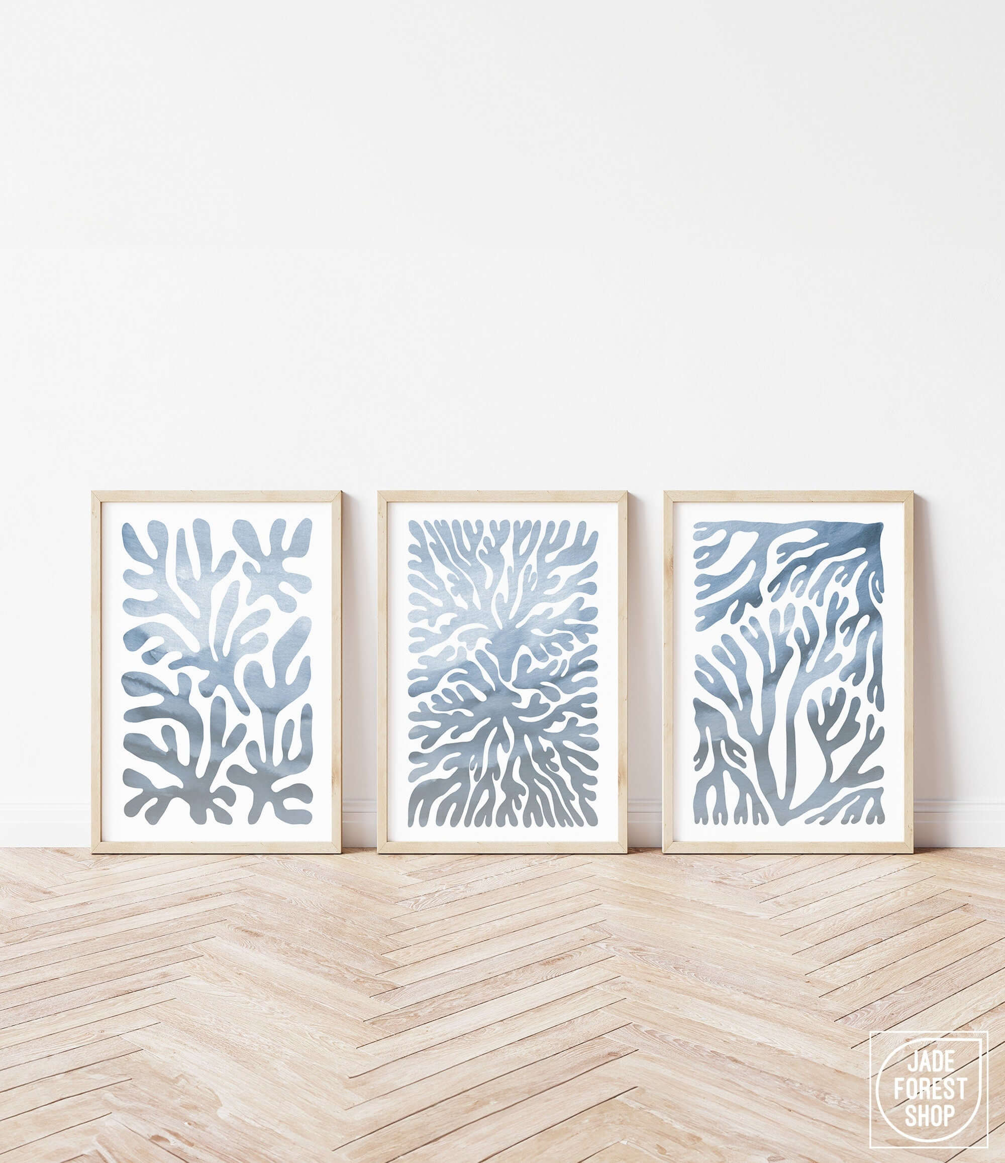 three framed art prints of blue corals against a white wall