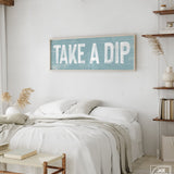 a bedroom with a bed and a sign on the wall