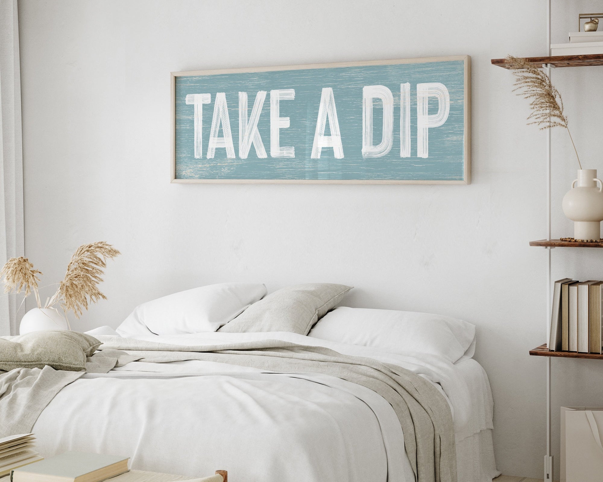 a bedroom with a bed and a sign on the wall