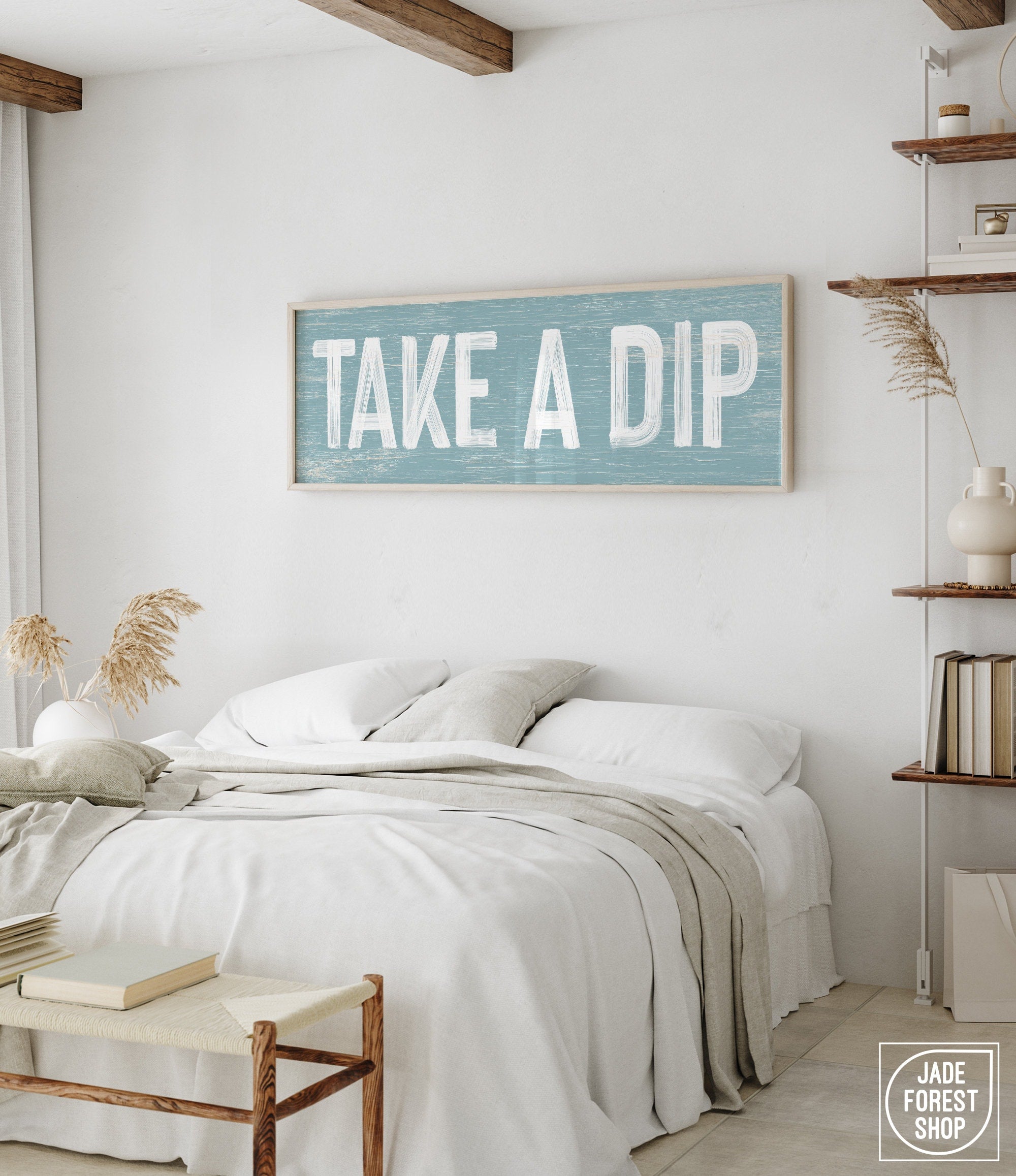 a bedroom with a bed and a sign on the wall