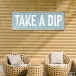 a sign that says take a dip on a wall