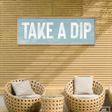 a sign that says take a dip on a wall