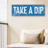 a blue sign that says take a dip on a wall