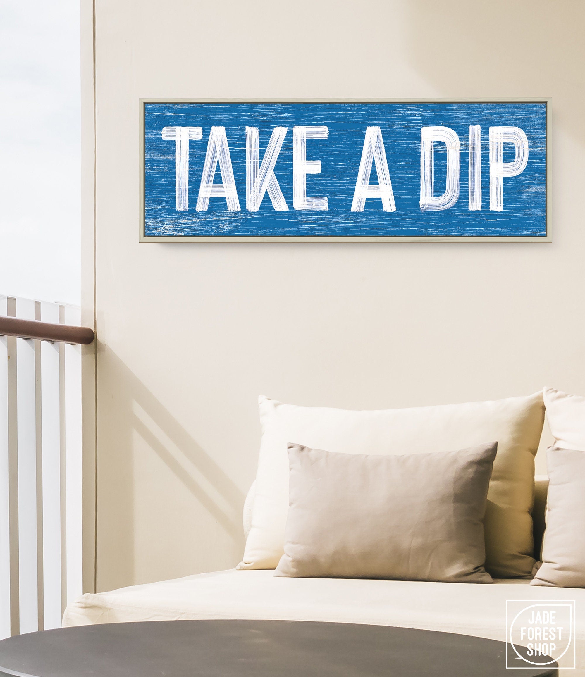 a blue sign that says take a dip on a wall