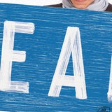 a woman holding a sign that says eat