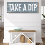 a wooden sign that says take a dip on a wall