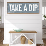 a wooden sign that says take a dip on a wall