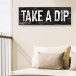 a sign that says take a dip on a wall