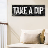 a sign that says take a dip on a wall