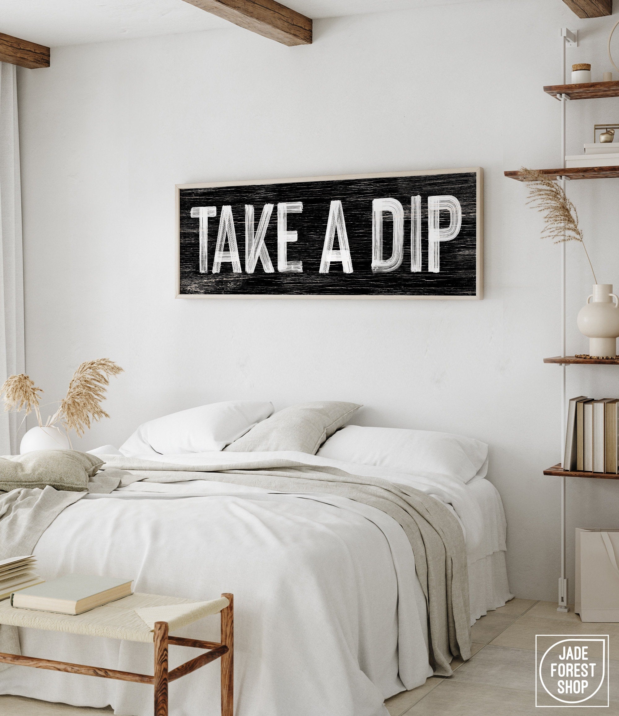 a bedroom with a bed and a wooden sign on the wall