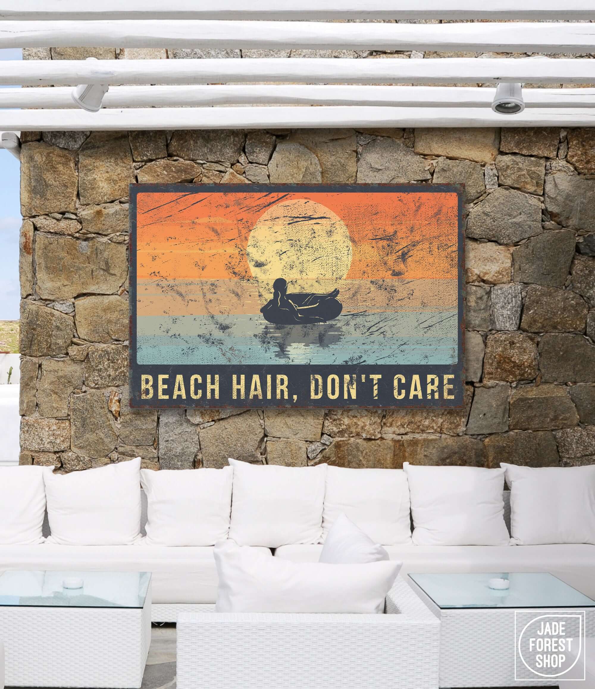 a stone wall with a sign that says beach hair don't care