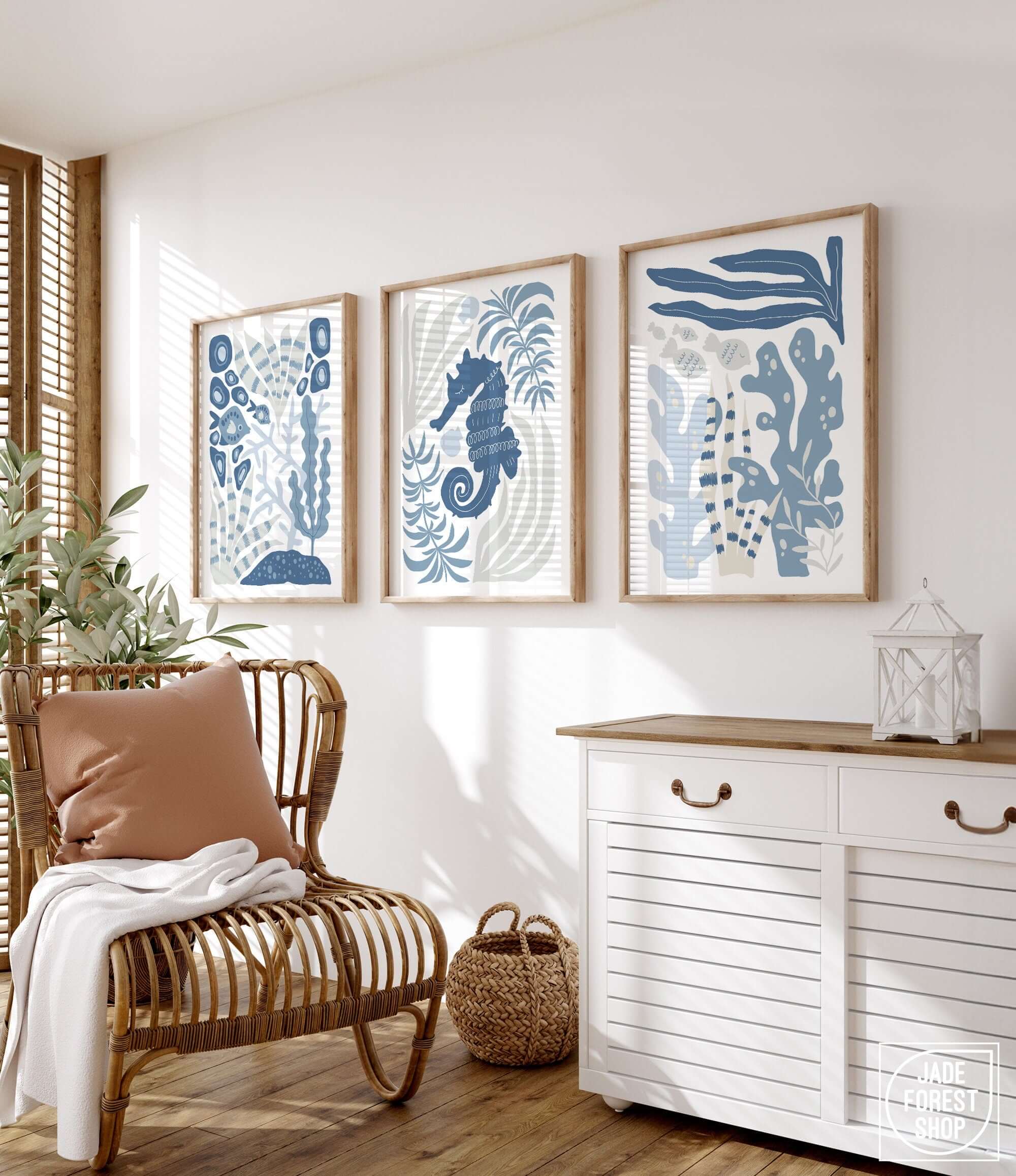 a living room with a chair and three paintings on the wall