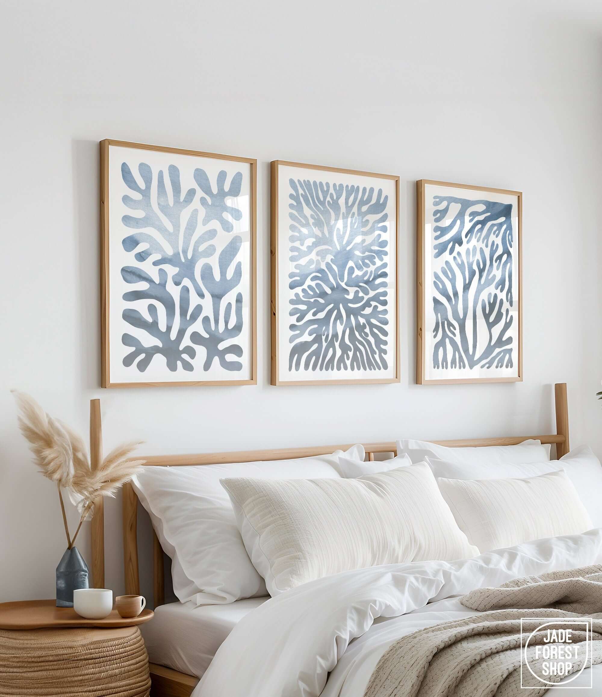 a bed with white sheets and pillows in a bedroom