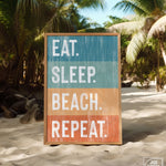 a sign on the beach that says eat sleep beach repeat