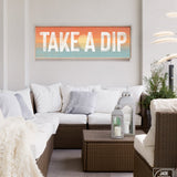 Take a dip sign with sunset background above an outdoor couch patio