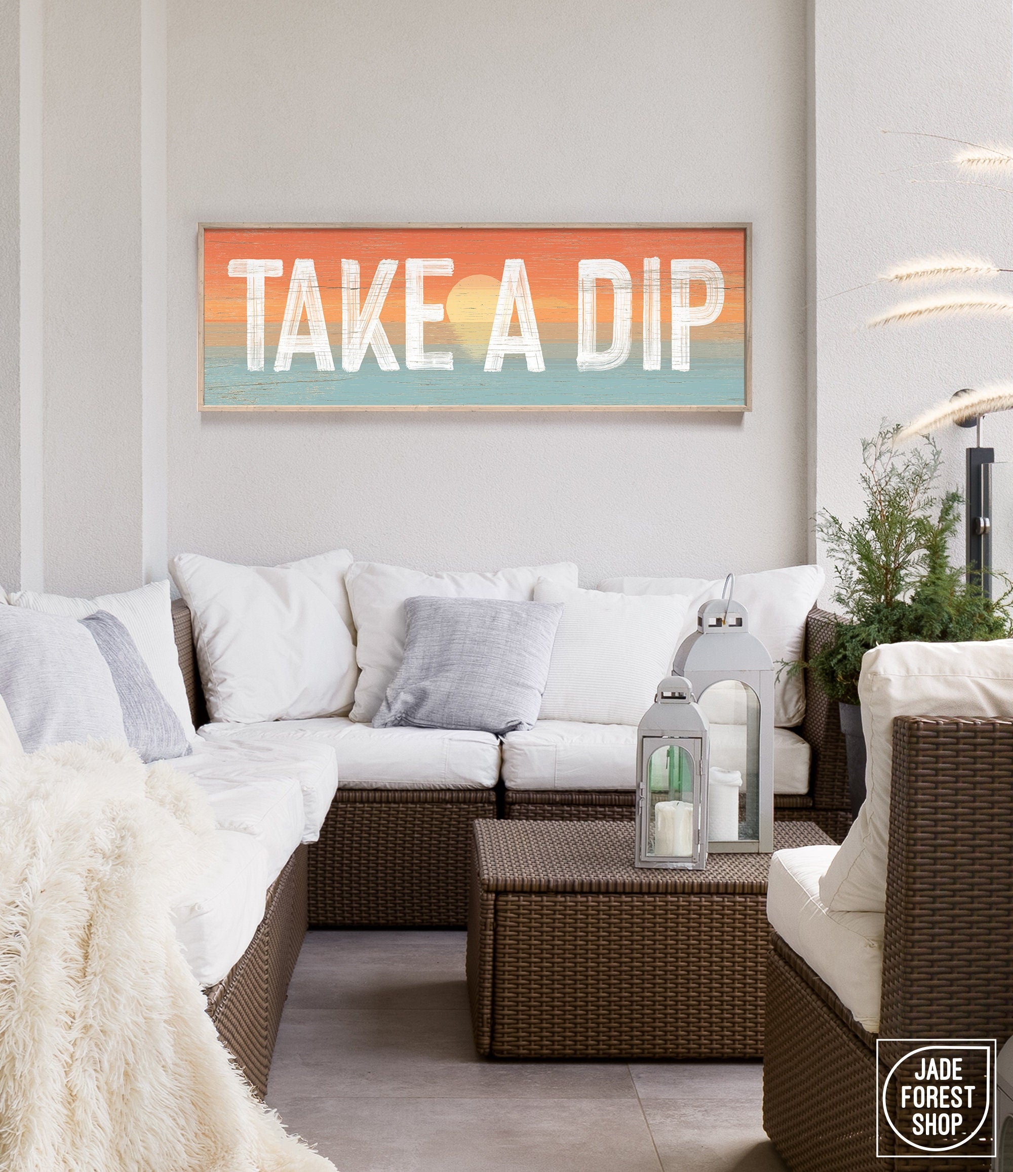 Take a dip sign with sunset background above an outdoor couch patio