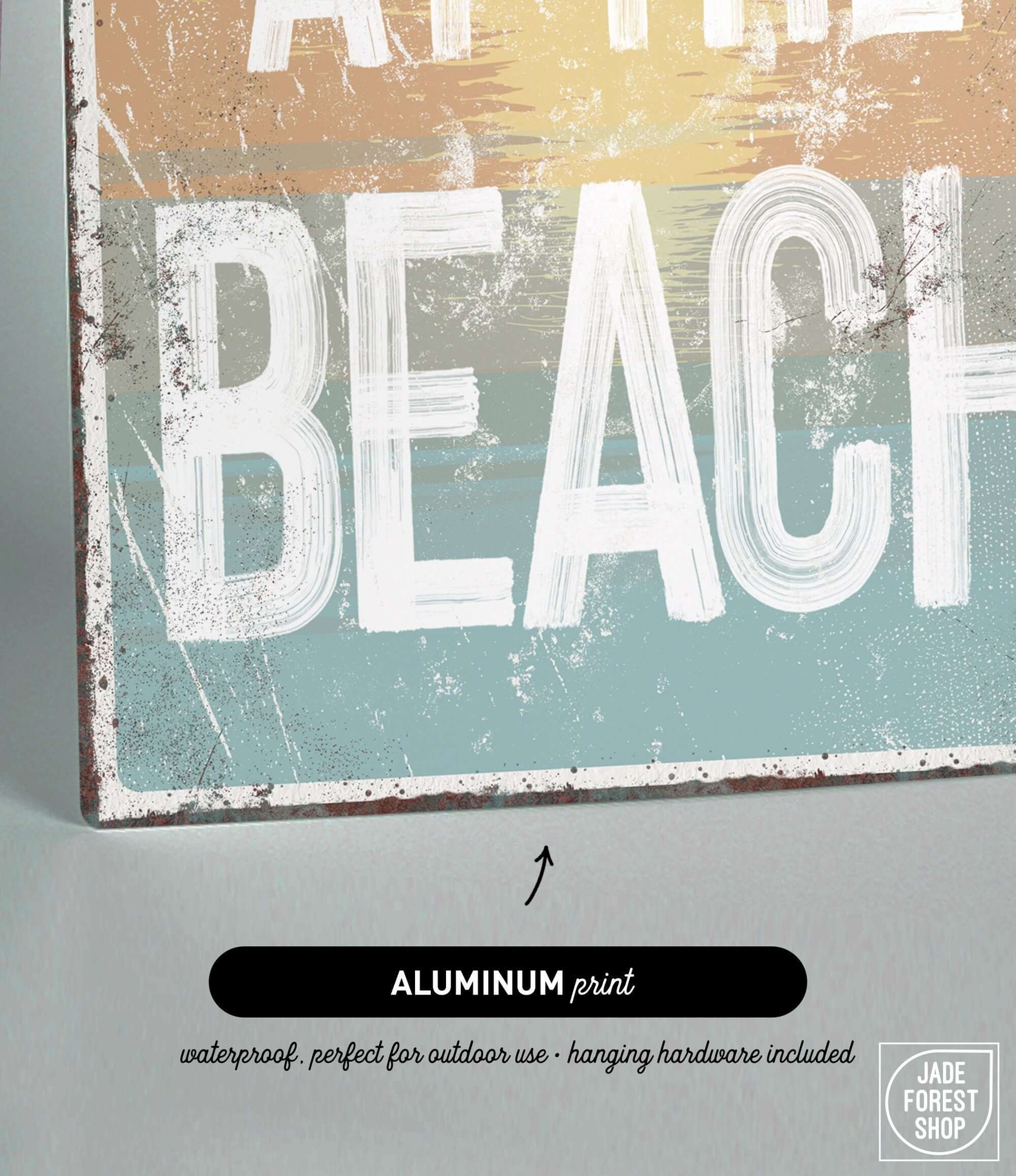 a metal sign that says at the beach